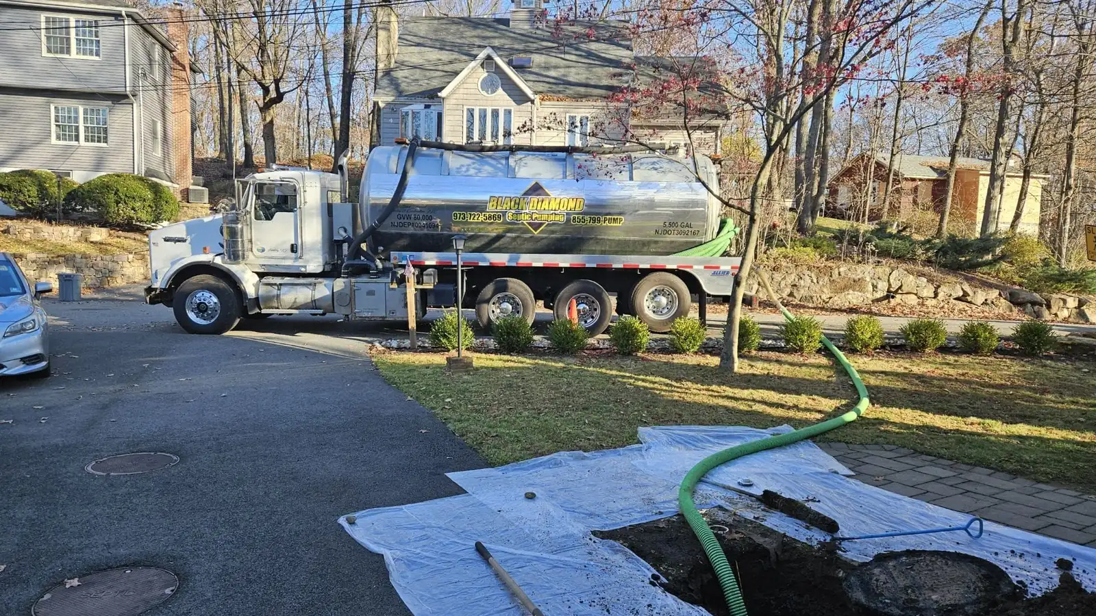 Black Diamond Septic Pumping tanker truck pumping a residential septic tank at a home in northern New Jersey
